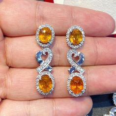 ENJOY OUR WORRY-FREE SERVICE AND THE DAZZLING, GENUINE JEWELRY WE DESIGN AND HANDCRAFT WITH LOVE❤️ ABOUT THE ITEM: SPARKLING! SHIMMERING, DANGLING VIVID ORANGE YELLOW SAPPHIRE EARRINGS! SO PRECIOUS! CERTIFIED 12.68 Total Carats, with 4 pieces of Thai yellow sapphires and 1.21 carats of F/VS, natural diamonds, set in handmade 10.0 grams, 18K solid white gold, CHIC dangling earrings. One of a kind! At 3.6 centimeter in drop length, perfect for both formal and causal events! ONE OF A KIND HANDCRAFT Fine Jewelry Oval Earrings With High Luster, Luxury Citrine Earrings, Exquisite Oval Diamond Earrings For Anniversary, Luxury Oval Diamond Earrings For Gift, Yellow Oval Fine Jewelry Earrings, Exquisite Oval Diamond Cut Earrings, High Luster Diamond Earrings For Gift, Yellow Oval Earrings In Fine Jewelry Style, Yellow Oval Earrings Fine Jewelry