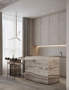 a modern kitchen with marble counter tops and cabinets