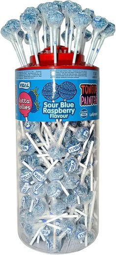 a jar filled with lots of blue raspberry flavored lollipops