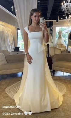 a woman is taking a selfie in her wedding dress