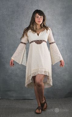 Luna Lace Dress  100% cotton lace dress embroidered with Celtic knot work. Colour - White This dress features a fanned bell sleeve and high low skirt design.  Celtic knotwork is always cyclical and never-ending. In this way, we have chosen to use Celtic knotwork in our designs as a symbol for the endurance of the ancient culture where they originated. Through our designs, we hope to help continue the ideas that Celtic culture symbolises. Using knotwork not only helps to keep that ancient form of Celtic Triple Goddess, White Cotton Dress With Scalloped Lace, Festival Dresses With Lace Sleeves, V-neck Lace Dress With Lace Cuffs, Lace Sleeve Dresses For Festivals, Fitted Cotton Dress With Scalloped Lace, White Gothic Summer Dress, Cotton Scalloped Lace Fitted Dress, Bohemian Fitted Long Sleeve Lace Dress