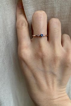 Genuine sapphire-adorned three stone ring. 14k Rose gold fully hallmarked 3mm blue Sapphire center stone. 1.75mm White Sapphires Approx 1.5mm band width FREE SHIPPING USA- All of our jewelry will arrive in custom packaging ready for gift giving. LEAD TIME: Made to order will take 10-14 days. Signature upon delivery, we unfortunately will not be able to reimburse or replace lost or stolen shipments. FOLLOW US ON: Instagram: @roseandchoc Facebook: /Roseandchoc Pinterest: @Roseandchoc 14k Rose Gold Sapphire Ring, Rose Gold Sapphire Ring With Round Band, Three Stone 14k Gold Sapphire Promise Ring, Anniversary Sapphire Ring In 14k Rose Gold, Fine Jewelry In Rose Gold With Three Stones, Rose Gold Sapphire Ring With Round Cut, Rose Gold Sapphire Ring With Gemstone, Sapphire Birthstone Ring With Bezel Setting For Promise, Rose Gold Round Sapphire Ring