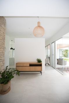 a living room filled with furniture and plants