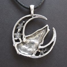 A howling wolf sings to the night skies and crescent moon. This lovely openwork pendant is sure to appeal to your wild side!The pendant comes on a black woven cord that adjusts with sliding knots. Made in the United States of lead-free pewter.Material: Lead-free pewter Dimensions: Approx. 1.25 inches (diameter), 1.5 inches (height with bail) Designer: Paths of the SpiritAbout the Wolf The Wolf is a powerful hunter on its own, but also knows the power of the pack! The Wolf totem stands for instin Moon Amulet, Wolf Totem, Howling Wolf, Wolf Spirit, Pewter Pendant, Wolf Howling, The Wolf, Crescent Moon, Night Skies