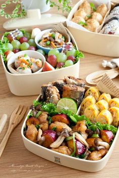 three containers filled with food sitting on top of a wooden table next to utensils