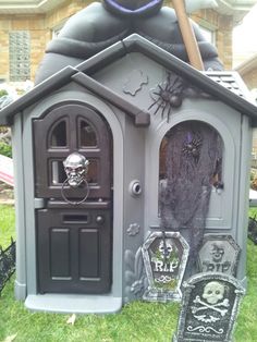 an outdoor halloween house with decorations on the lawn