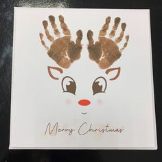 a handprinted christmas card with a reindeer's head