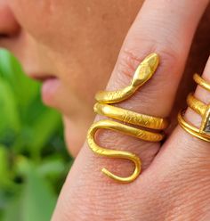 This is a thick, solid, and heavy 24k gold snake ring. Each one is individually hand-made by me, no two are identical. The Snake wraps around the finger twice, and it's body is around 3mm wide. I have seen some really ancient versions of this ring, that is what inspired me to make this rendition. Thanks for checking this ring out! Please look at my customer reviews, I try really hard to please. Gold Snake Ring Gift, Snake-shaped Yellow Gold Wedding Ring, Adjustable Gold Snake Ring, Handmade Gold Snake Ring, Gold Snake-shaped Ring For Anniversary, Gold Snake Shape Rings For Anniversary, Adjustable Yellow Gold Snake-shaped Ring, Adjustable Gold Snake Ring Symbolic, Unique Gold Snake Ring For Wedding