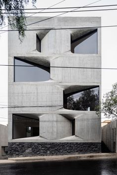 the building is made out of concrete and has multiple windows