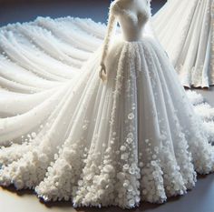 a dress made out of white flowers on display in front of a mannequin