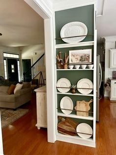 a shelf with plates on it in a living room