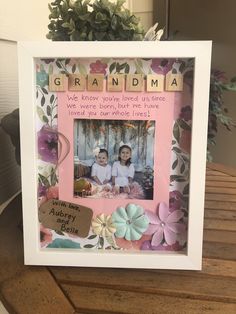 a photo frame with flowers and words on it