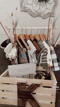 a wooden crate filled with lots of clothes