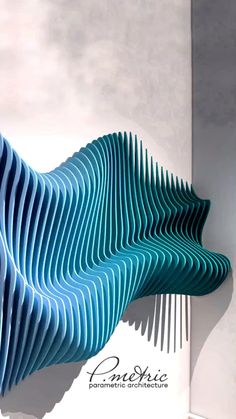 an artistic sculpture made out of blue strips on the wall next to a white building