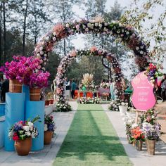 an outdoor ceremony with flowers and decorations