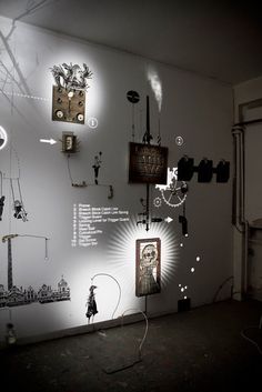 a room with various items on the wall and lights in the ceiling, including clocks