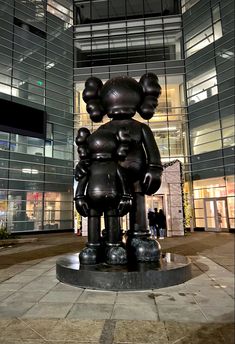 a statue of two people holding hands in front of a building