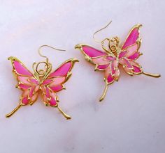 Pink Handmade Enchanted Butterfly Earrings with Gold plated butterfly bezel Pink Fairycore Earrings As Gift, Fairycore Pink Earrings As Gift, Fairycore Pink Earrings For Gifts, Whimsical Butterfly Charm Earrings For Gift, Pink Butterfly Jewelry With Matching Earrings, Nickel-free Butterfly Jewelry For Party, Whimsical Pink Butterfly Jewelry, Butterfly Charm Wing-shaped Earrings For Gift, Butterfly Charm Earrings As Gift