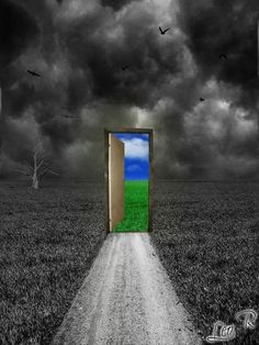 an open door in the middle of a dirt road leading to a field with birds flying overhead