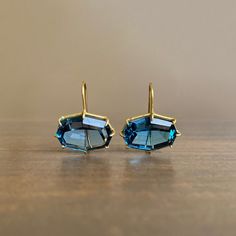 Deep blue hues and flashing facets are framed by rich yellow gold in this head-turning pair. 18k yellow gold London blue topaz, 17mm x 13mm (5/8" x 1/2") Earrings hang 7/8" from the ear Each earring weighs 3.5g Luxury Octagon Earrings For Formal Occasions, Luxury Blue Topaz Brilliant Cut Earrings, Luxury Blue Topaz Jewelry With Matching Earrings, Luxury Multi-stone Blue Topaz Earrings, Luxury Modern Blue Topaz Earrings, Luxury Faceted Topaz Jewelry, Luxury Blue Cabochon Earrings, Luxury Octagon Topaz Jewelry, Luxury Blue Topaz Dangle Earrings