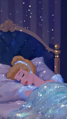 a woman laying in bed under a blue blanket with stars on it's head