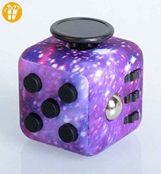 a purple and black dice sitting on top of a table