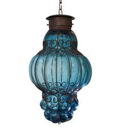 a blue glass lantern hanging from a ceiling