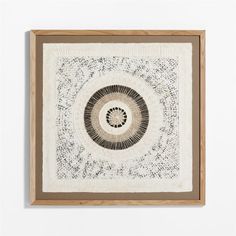 a white wall hanging on the side of a wall with a black and white circular design