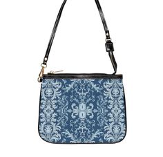 This unique and vibrant shoulder bag adds a chic touch to any outfit. Its compact size (10"w x 8"h) and lightweight construction makes it the perfect accessory for carrying around your essentials in style. Our one of a kind purse features an archival fabric design in baroque flourishes of sapphire, sky and pale blues. This gorgeous design is printed onto high-grade vegan leather and shipped to you by our top-rated production partner. We also offer the coordinating vegan wallet: https://thecheekyshedonist.etsy.com/listing/1680599038 .: 100% high-grade vegan leather exterior .: Polyester lining + 20-inch black strap .: Two open pockets inside .: Gold-toned zipper and hardware .: Original + unique art history design exclusively available at The Cheeky Shedonist  Care instructions: avoid prolo Luxury Blue Baguette Bag For Everyday Use, Elegant Blue Baguette Bag With Detachable Strap, Elegant Blue Baguette Bag With Removable Pouch, Blue Rectangular Baguette Bag With Adjustable Strap, Blue Satchel Baguette Bag With Detachable Strap, Blue Crossbody Baguette Bag With Detachable Strap, Blue Baguette Satchel Bag With Detachable Strap, Blue Baguette Bag With Removable Pouch For Everyday, Blue Baguette Bag With Detachable Strap For Daily Use