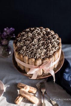 a cake with chocolate frosting and sprinkles sitting on top of a table