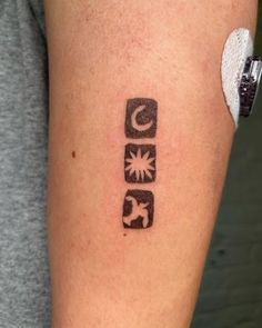 a person with a tattoo on their arm that has the letter c in black ink