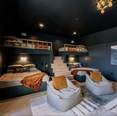 a room with bunk beds and couches in the middle, two on each side