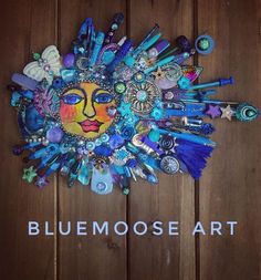 the blue moose art logo is surrounded by other items on a wooden surface with words above it