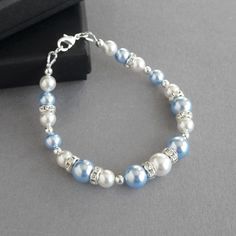 "This light blue pearl and crystal bridesmaid bracelet combines the lustre of glass pearls and the sparkle of faceted crystals. These pale blue single strand bracelets would make an ideal \"something blue\" gift for a bride or a pretty keepsake for a bridesmaid. These powder sky blue bracelets measure 7 inches in length and are fitted with a 1 inch extension chain to allow the user to adjust the bracelet to fit. All fittings are silver plated. Your pastel baby blue jewellery will arrive carefully gift wrapped in a pretty, black box - ready to present or simply unwrap as a treat to yourself. --------------------- Matching items available --------------------- Light blue pearl jewellery set: https://www.etsy.com/listing/513685532 Light blue pearl necklace: https://www.etsy.com/listing/527481 Baby Blue Coquette, Baby Blue Jewelry, Pastel Blue Wedding, Light Blue Bracelet, Chunky Stone Necklace, Bridesmaid Pearl Bracelet, Blue Bracelets, Blue Jewelry Set, Blue Wedding Jewelry