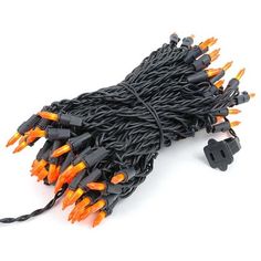 black and orange christmas lights on white background