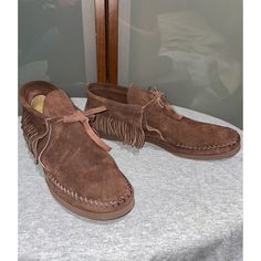 Step Out In Style With These Vintage Quoddy Deerskin Leather Fringe Flat Moccasins Chukka Ankle Boots In Brown. The Boots Feature An Almond Toe Shape, Tie Closure, And Adjustable Strap For Comfort And Ease Of Wear. The Lightweight Design And Rubber Outsole Make Them Perfect For All Seasons, Whether You're Traveling Or Going For A Casual Look. Handmade With Deer Skin And One Of A Kind, The Boots Are Accented With Fringe And A Strap, Giving Them A Hippie, Bohemian, 70s Theme. With A Solid Pattern And M Shoe Width, These Moccasin Boots Have A Flat (Under 1 In) Heel Height And Are Available In Us Shoe Size 9 , Uk Shoe Size 7, And Eu Shoe Size 40. Get Your Hands On This Product From The Quoddy P Western Style Suede Moc Toe Boots, Vintage Suede Moccasins With Round Toe, Western Style Closed Toe Moccasins For Fall, Vintage Round Toe Moccasins For Fall, Brown Moc Toe Moccasins For Fall, Vintage Suede Moccasins, Fall Western Closed Toe Moccasins, Casual High-top Leather Moccasins, Western Suede Moccasins For Fall