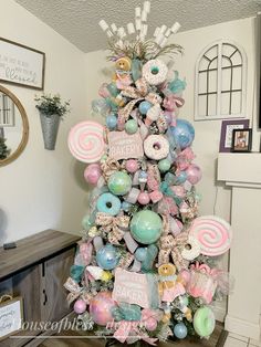 a christmas tree decorated with lollipops, marshmallows and donuts