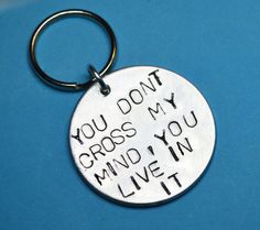 a metal keychain that says you don't cross my mind, you live in it