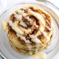 a stack of cinnamon rolls sitting on top of a white plate