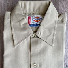 New Dickies Short Sleeve Work-Shirt Regular Fit Flaw: Dirt/Small Mark, Close To The Tag (See Pic) Color: Khaki Size: Small Short Sleeve Khaki Shirt For Work, Fitted Khaki Button-up Shirt, Classic Khaki Cotton Shirt, Fitted Khaki Collared Shirt, Classic Long Sleeve T-shirt For Work, Khaki Collared Cotton Blouse, Khaki Cotton Collared Blouse, Collared Cotton Blouse In Khaki, Khaki Short Sleeve Shirt With Button Closure