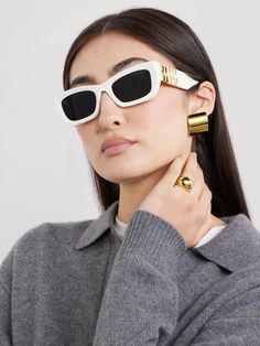 It's hard to beat the sartorial impact of a pair of statement sunglasses. Miu Miu's playfully named 'Glimpse' style take cues from old Hollywood, characterized by bold, oversized square frames. They're fitted with smoked UV-protective lenses and feature the label's moniker at the temples. Miumiu Sunglasses, Miu Miu Eyewear, Statement Sunglasses, Eyewear Trends, White Sunglasses, Sunglasses Collection, White Accessories