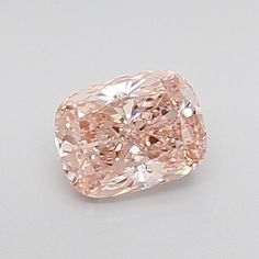 a fancy pink diamond sitting on top of a table