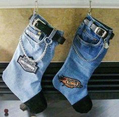 two pairs of jeans hanging on a radiator with chains attached to the legs