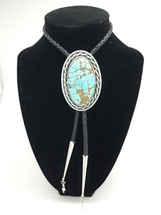 Number 8 Mine,  Oldstock Turquoise Bolo Tie. This one is on the larger size, with some really neat details.  This piece features a gem grade Turquoise cabochon, set in sterling. Simple and timeless, One of the many different looks from this mine. All of the turquoise chosen for my bolo ties is absolutely some of the best old stock that can be found. Always priced fairly to ensure value, these are heirloom caliber stones. This features a larger 5mm leather braided cord with sterling tips. Those a Classic Turquoise Oval Cabochon Jewelry, Artisan Turquoise Jewelry For Formal Occasions, Elegant Adjustable Turquoise Gemstone Necklace, Western Style Turquoise Gemstone Jewelry, Elegant Turquoise Concho Jewelry, Classic Oval Turquoise Jewelry, Adjustable Turquoise Luxury Jewelry, Adjustable Luxury Turquoise Jewelry, Elegant Blue Concho Jewelry