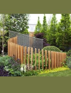 an outdoor garden with wooden posts and plants