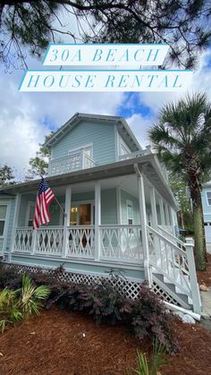 a blue house with an american flag on it's porch and the words, 30a beach house rental