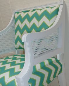 two white chairs with green and white chevron upholsters on the back