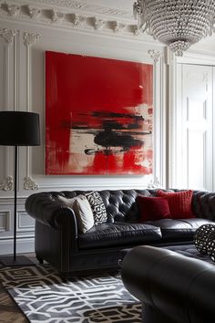 a living room filled with furniture and a large red painting on the wall above it