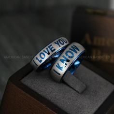 two rings with i love you know written on them sitting on top of a box