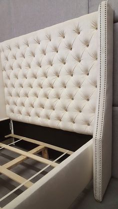 an upholstered bed frame with buttons on the headboard